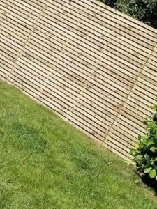 Close up of newly installed residential garden fence with horizontal wood slats