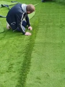 Close up of artificial lawn being repaired